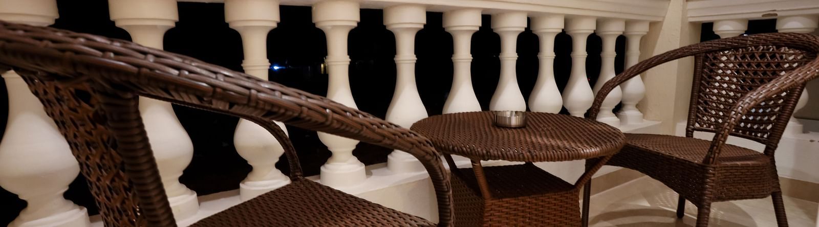 Image of a balcony with a table and two chairs beside it at Calux Grand Baga.